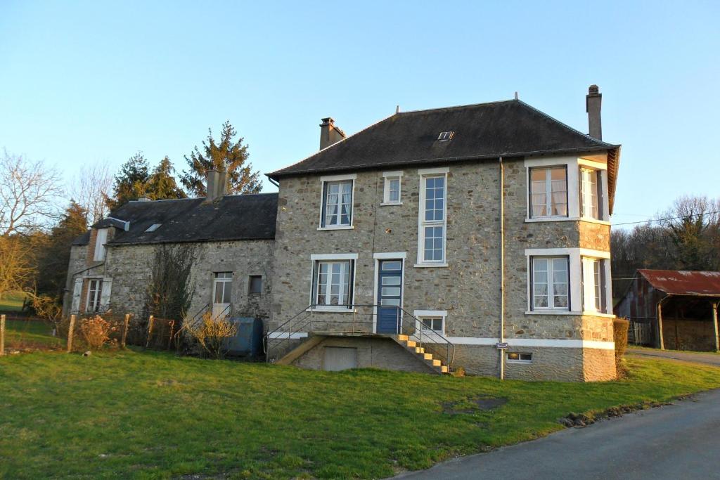 an old brick house on the side of a road at Les Hautes Loignieres in Pré-en-Pail