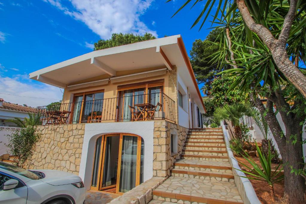 モライラにあるPedro - two story holiday home villa in El Portetの階段とバルコニー付きの家