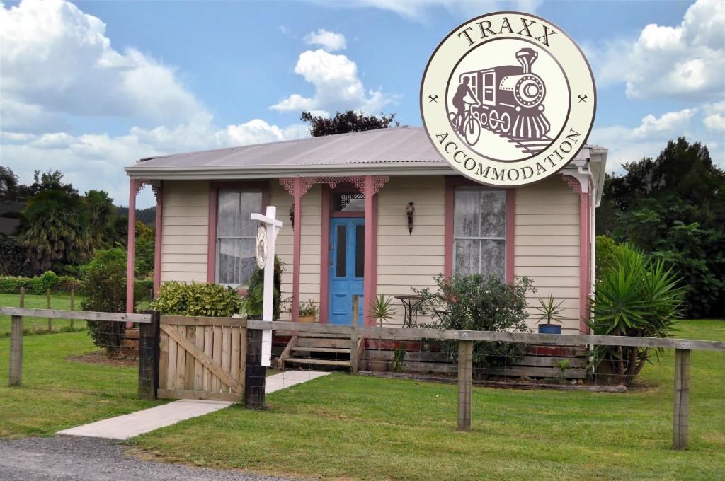 a small house with a train on it at Shunters Cottage in Waihi