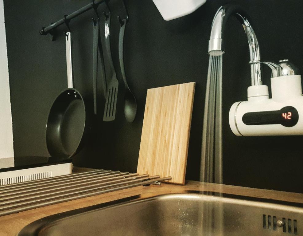 a kitchen with a sink and a kitchen utensils at Apartmani Vacanza in Zagreb
