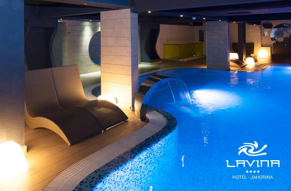 a large swimming pool in a hotel room with a swimming pool at Hotel Lavina in Jahorina