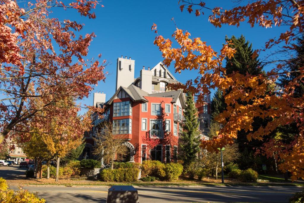 a house on a street with autumn leaves at Alpenglow Lodge by Bill in Whistler