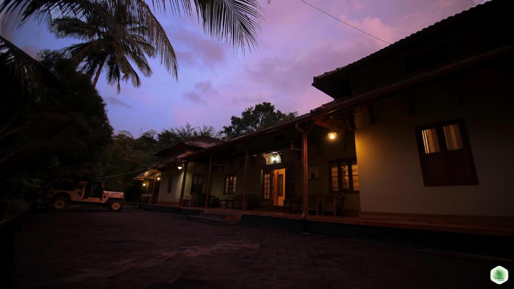 a night view of a house with a car parked outside at Hiliya Resort in Kenichira