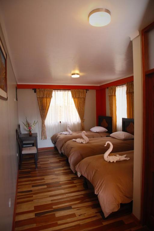 Postel nebo postele na pokoji v ubytování Tunupa Lodge Hotel