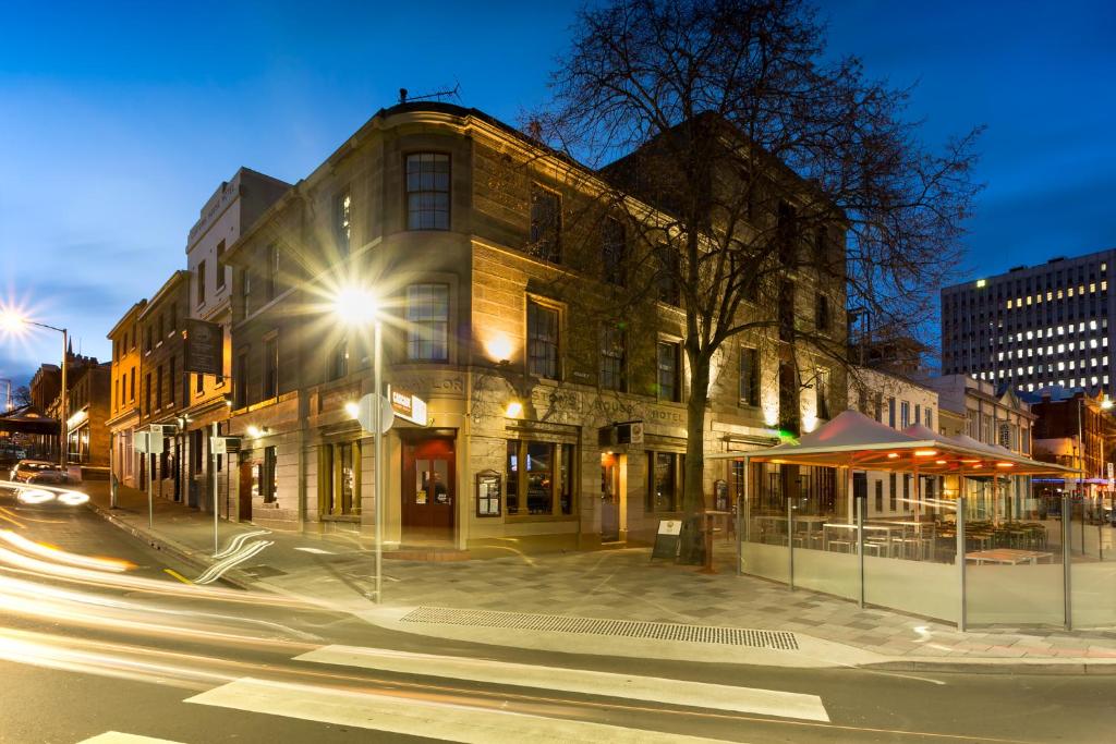 a city street at night with a building at Customs House Hotel in Hobart