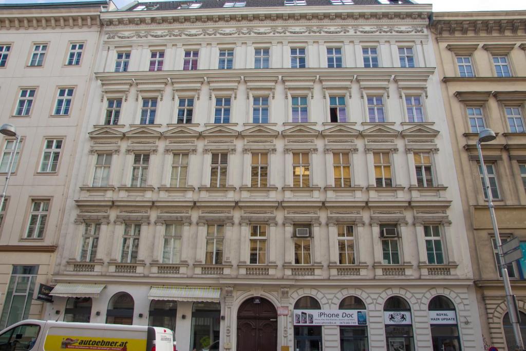 a large white building with many windows on a street at Vienna Hotspot in Vienna