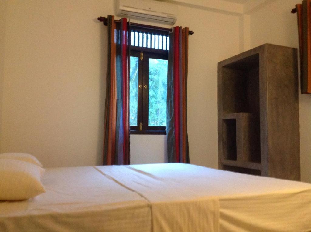 Postel nebo postele na pokoji v ubytování Sinharaja Hostel