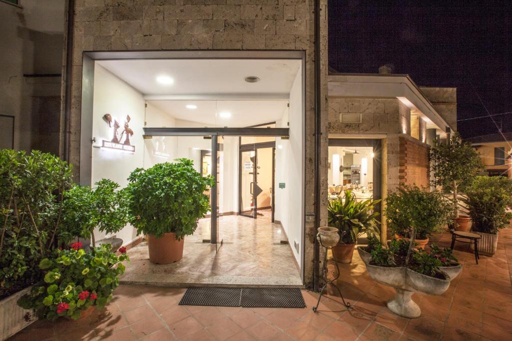 an open door of a building with potted plants at Albergo Vecchio Forno in Spoleto