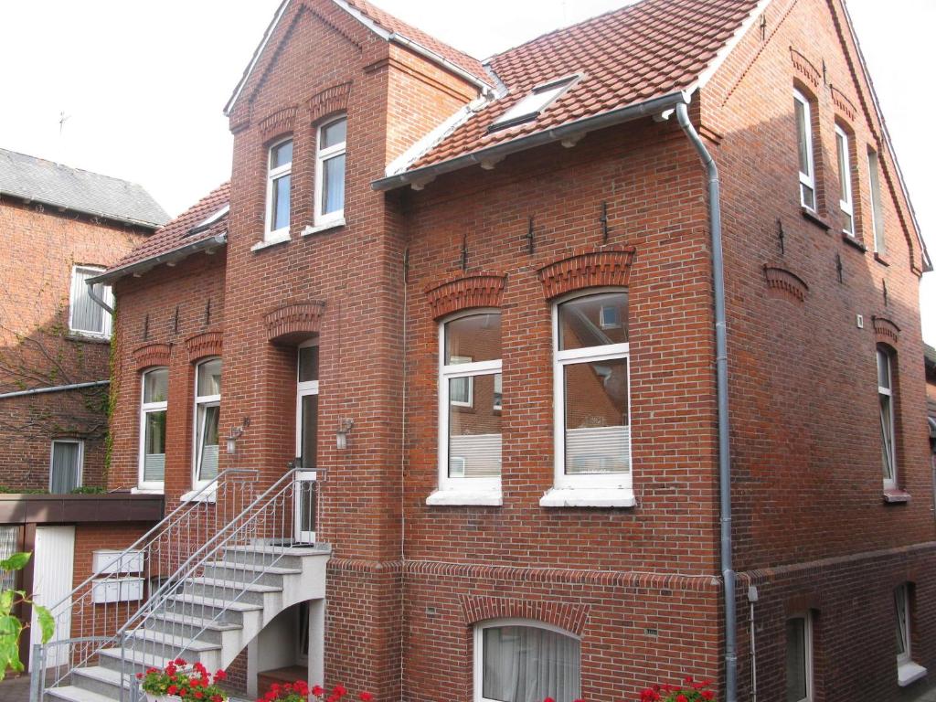 a brick building with a staircase on the side of it at Altstadtvilla in Borkum