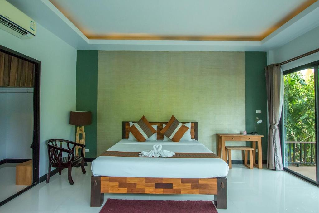 Postel nebo postele na pokoji v ubytování Himaphan Boutique Resort - SHA EXTRA PLUS
