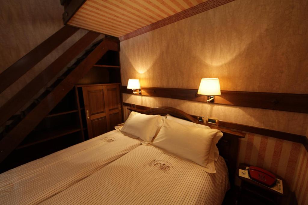Postel nebo postele na pokoji v ubytování Hotel Petit Prince