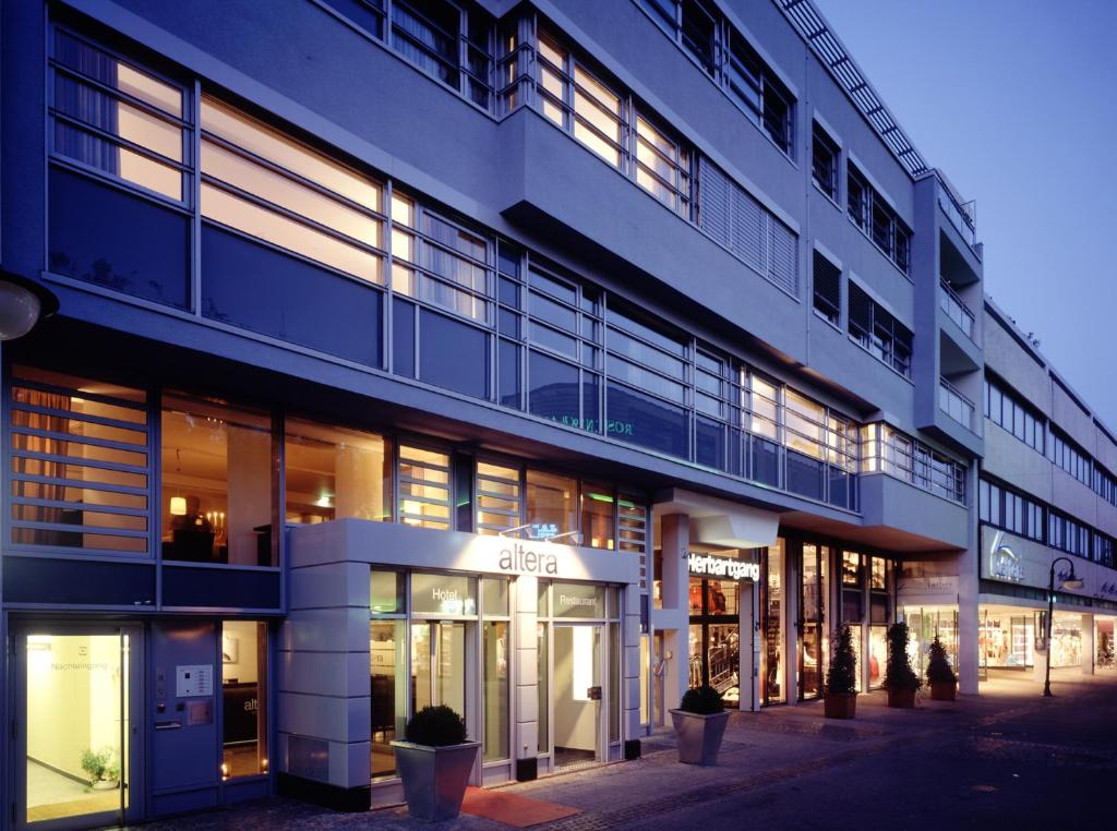 un gran edificio con muchas ventanas en una calle en Altera Hotel, en Oldenburg