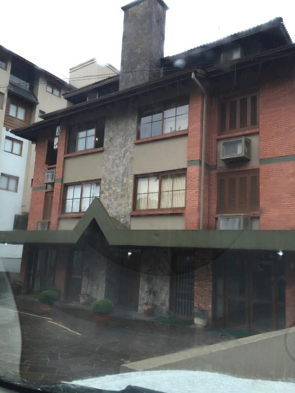 un gran edificio de ladrillo con ventanas en una calle en Res. Alcides Balzaretti, en Gramado