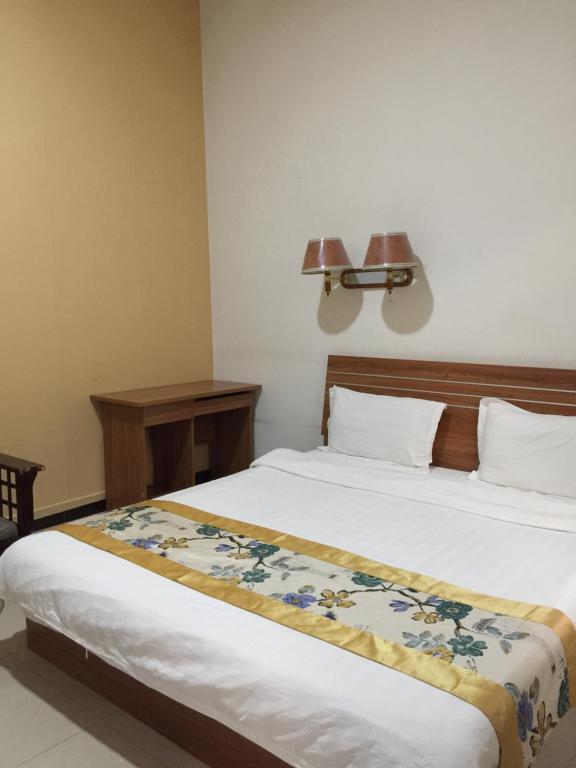 Postel nebo postele na pokoji v ubytování Huashan Gehui Hotel