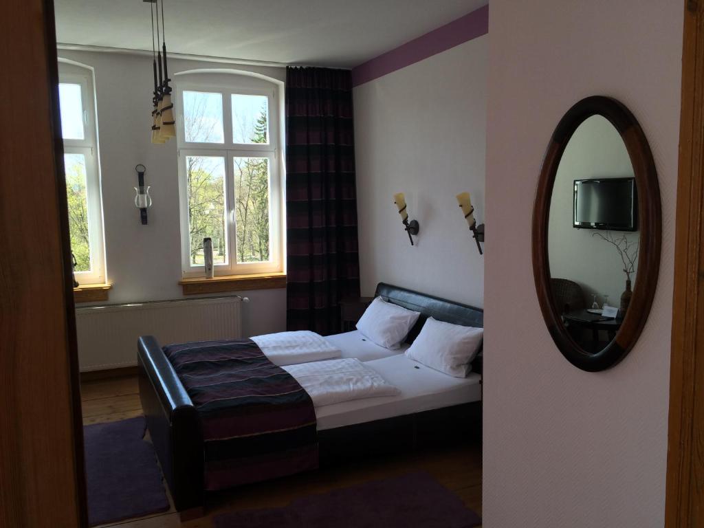 a bedroom with a bed and a mirror at Traumparadies in Bad Sulza