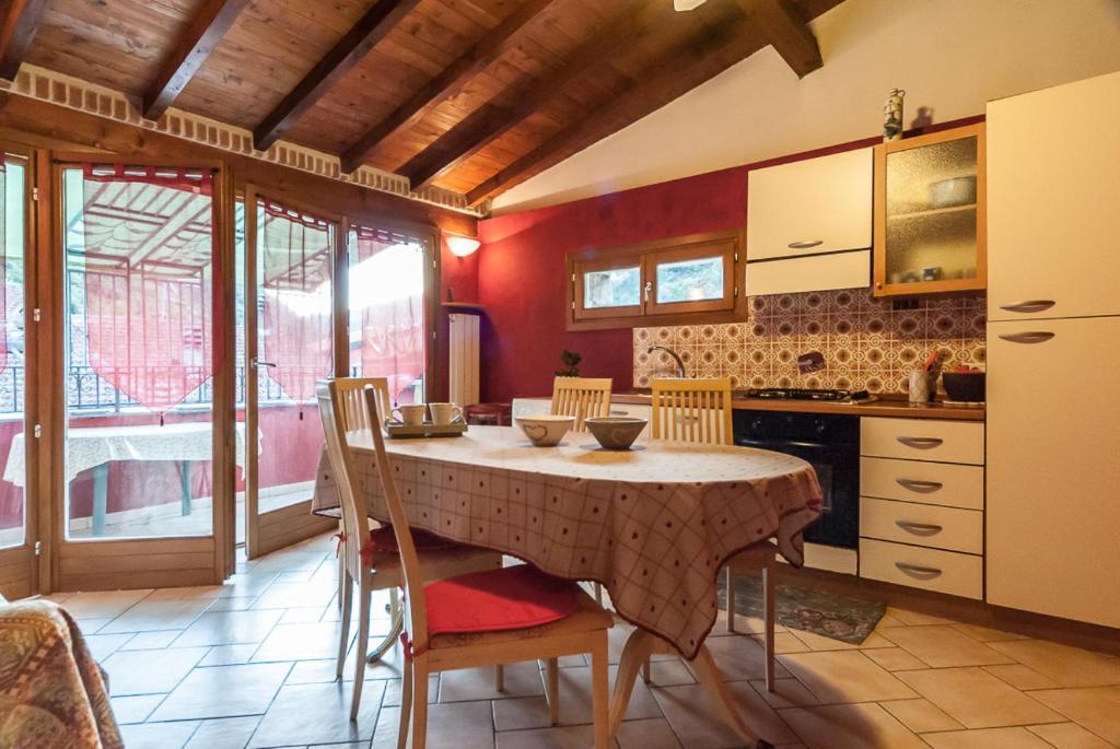 a kitchen with a table and chairs in a room at Casa Luigia in Isolabona