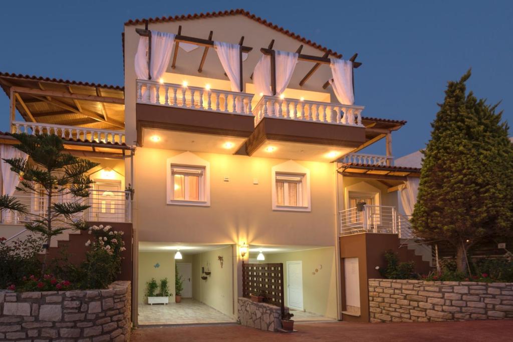 a large house with a balcony on top of it at Villa Apollon II in Sfakaki