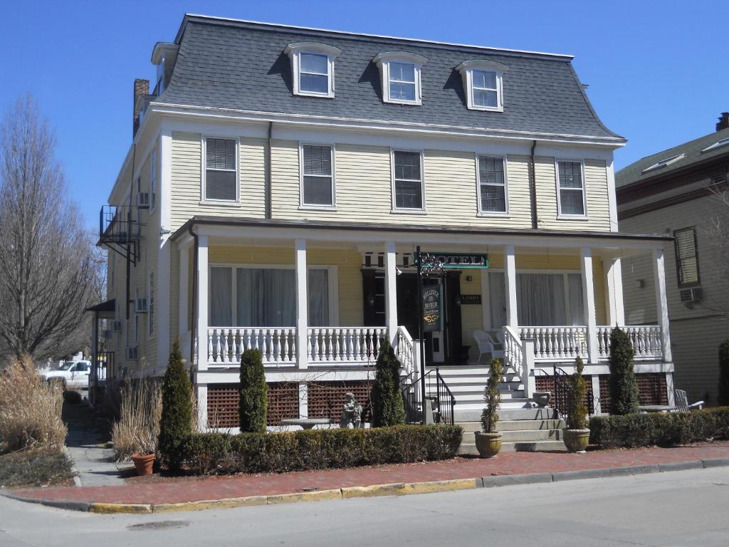 a large white house with a white porch and stairs at Bellevue Manor in Newport