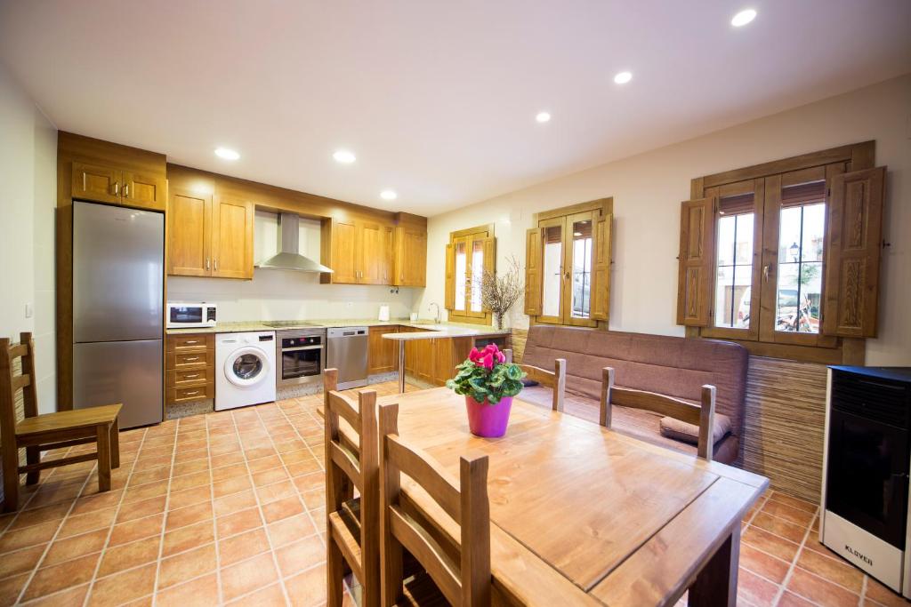 a kitchen with a wooden table and a dining room at Casa Rural Francisca in Requena