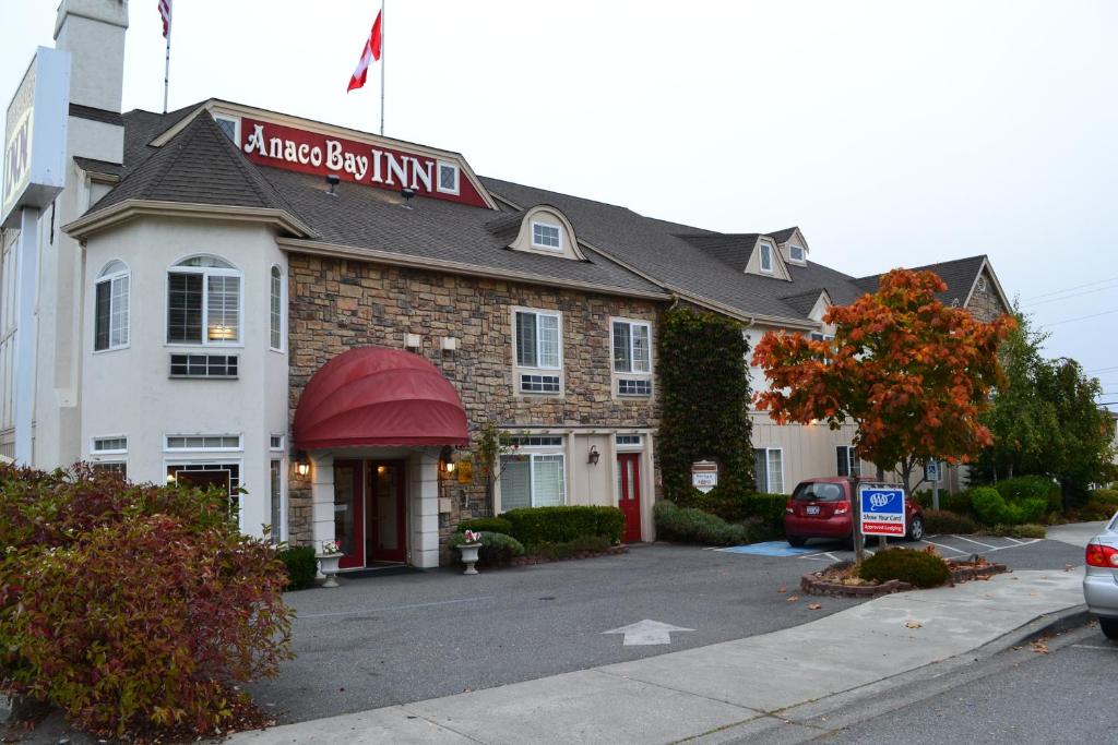 a hotel with a red sign on the front of it at Anaco Bay Inn in Anacortes