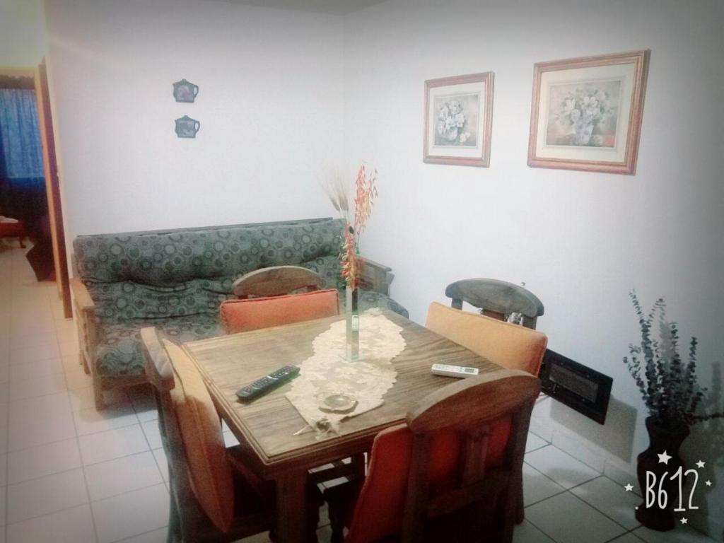 a dining room table with chairs and a couch at total servicios in Ciudad Lujan de Cuyo