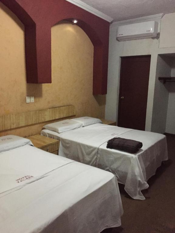 Postel nebo postele na pokoji v ubytování Hotel Xalapa