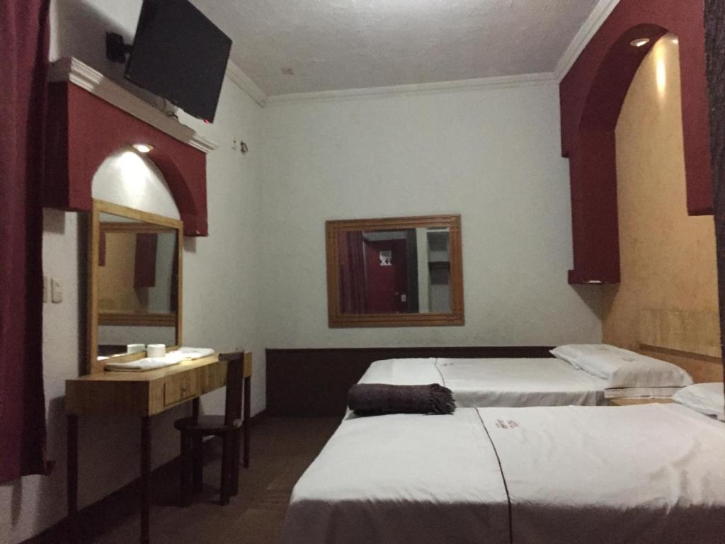 Postel nebo postele na pokoji v ubytování Hotel Xalapa