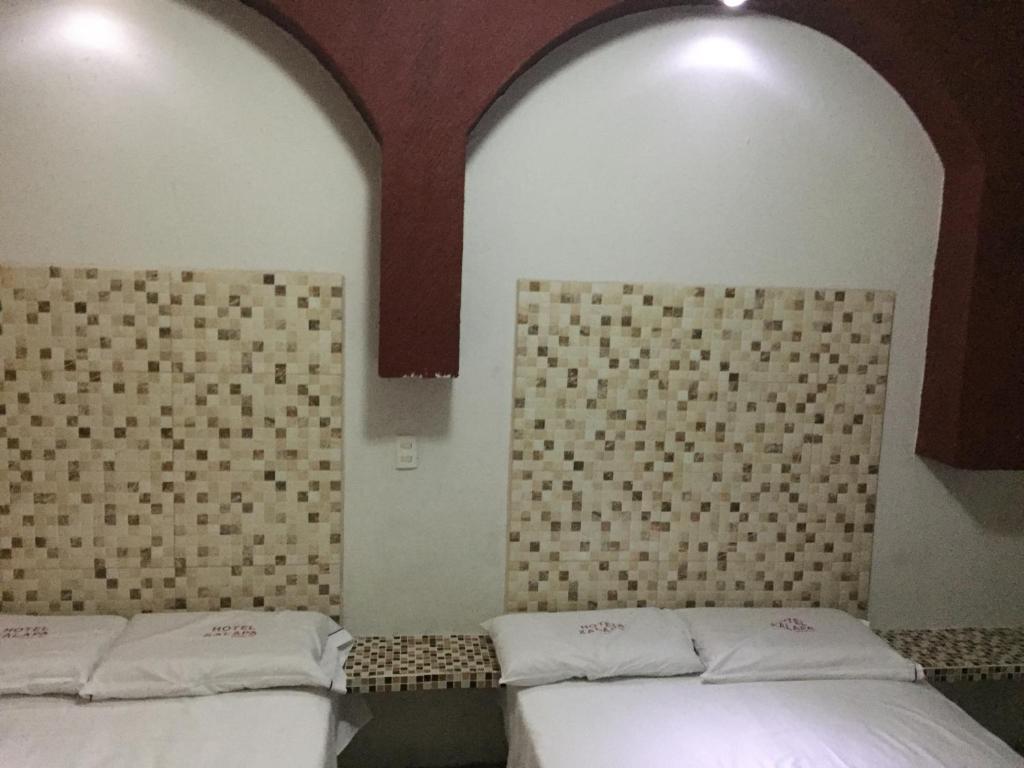 Postel nebo postele na pokoji v ubytování Hotel Xalapa