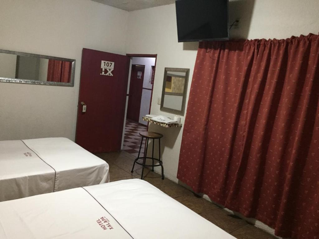 Postel nebo postele na pokoji v ubytování Hotel Xalapa