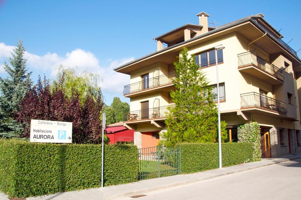 a building with a sign in front of it at Habitacions Aurora in Sant Pau de Seguries