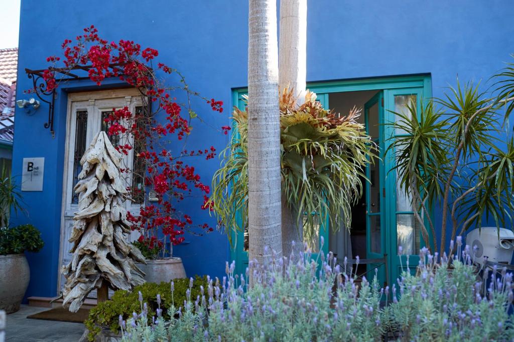 a blue house with plants in front of it at Bondi Beach House in Sydney