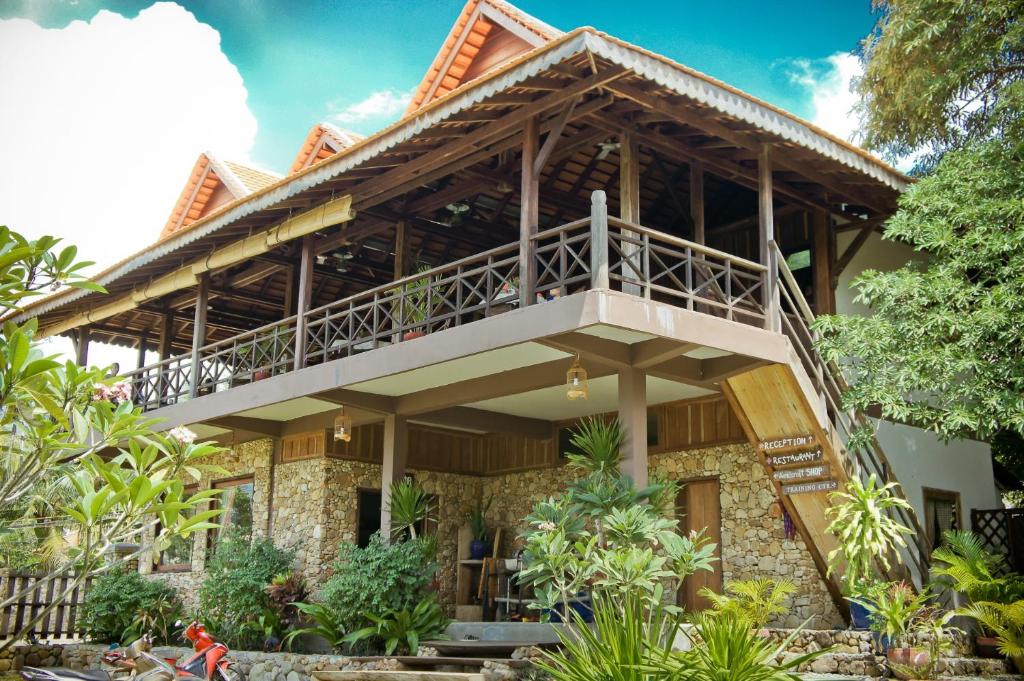 a house with a balcony on top of it at Khmer Hands in Kep
