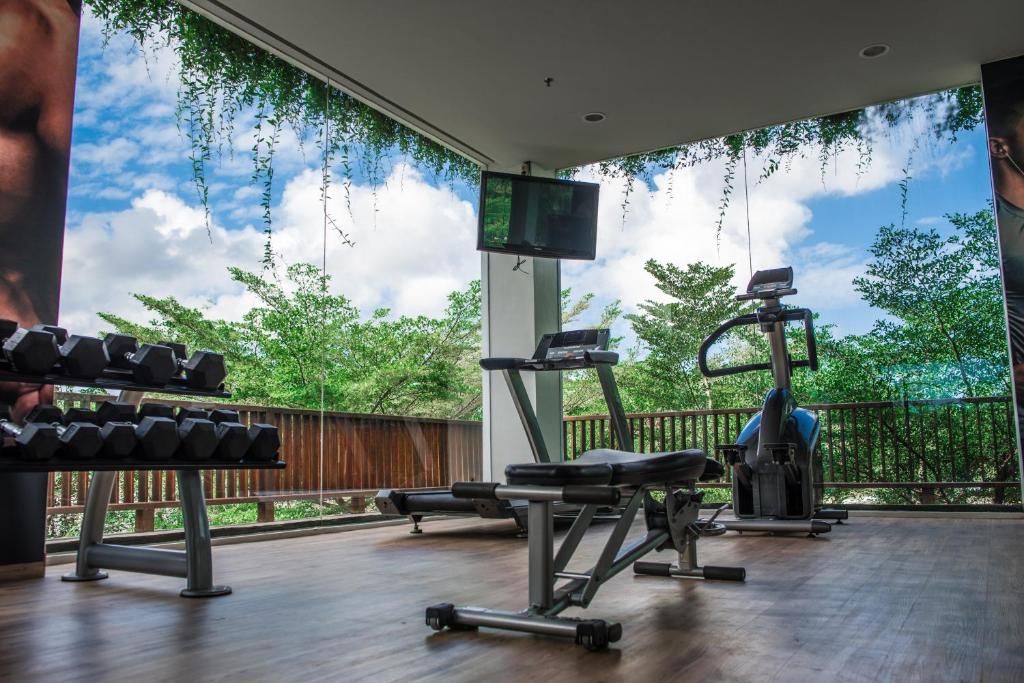 a gym with two tread machines and a large window at Anantara Uluwatu Bali Resort in Uluwatu