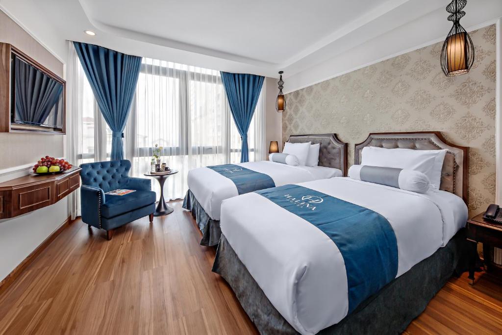 Postel nebo postele na pokoji v ubytování Halina Hotel and Apartment