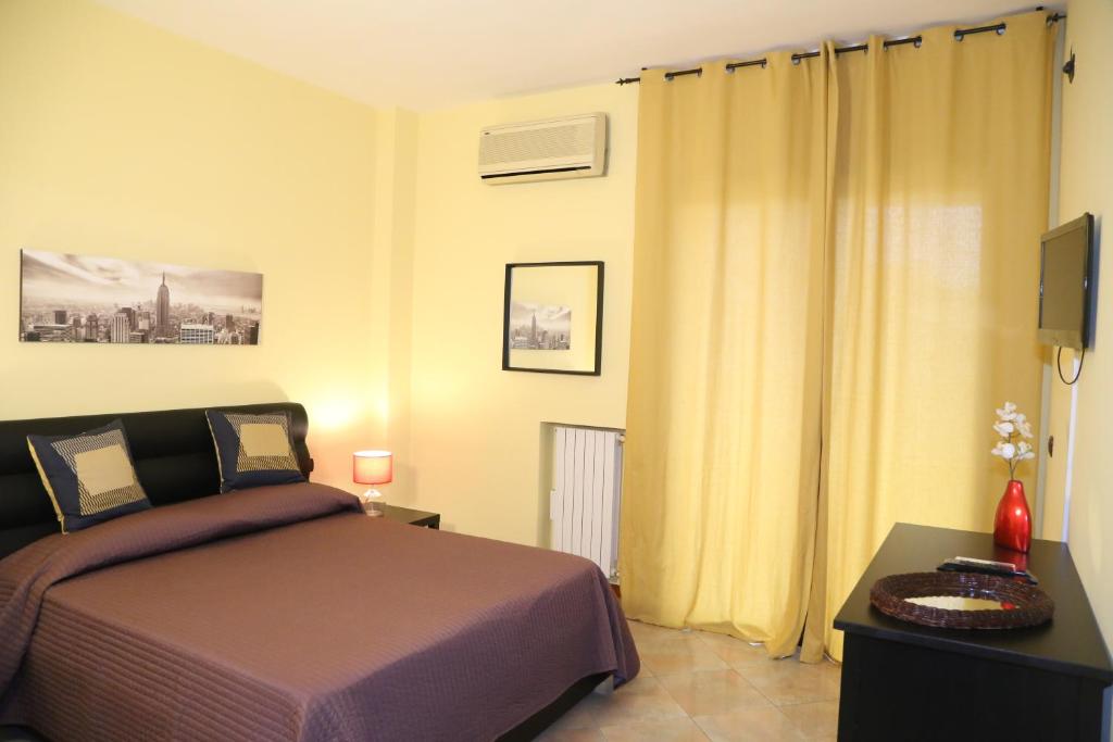 a bedroom with a bed and a television in it at Bari Suite Apartment Leader Palace - Free Parking ! in Bari