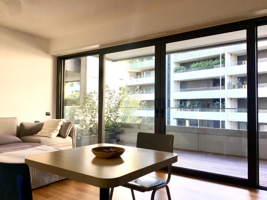 a living room with a table and a large window at Loft Giulietta in Milan