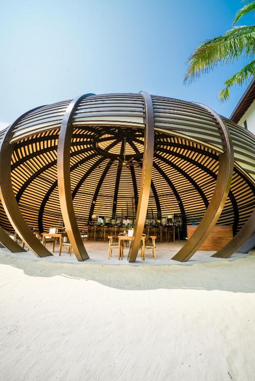 a large wooden bench sitting on the beach at Anantara Peace Haven Tangalle Resort in Tangalle