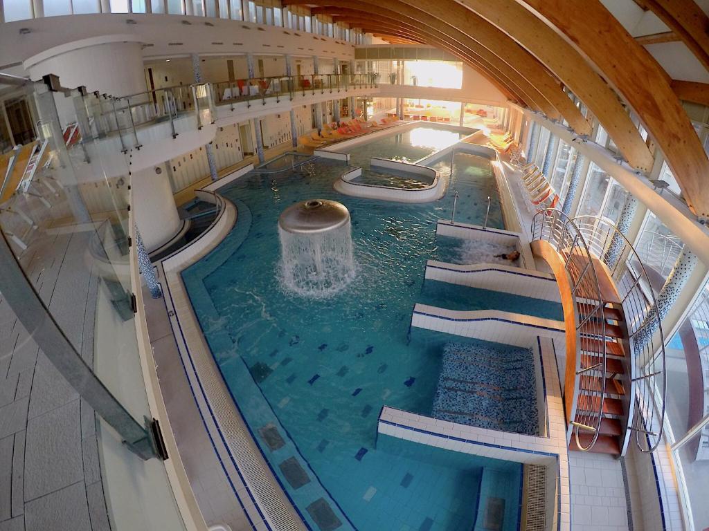 an indoor swimming pool on a cruise ship at Lake and Spa Apartman in Velence