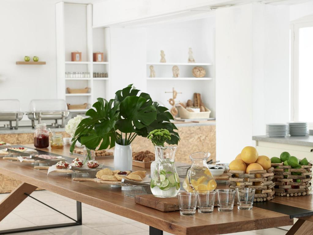 a table with food on it in a kitchen at Kouros Seasight Hotel in Pythagoreio