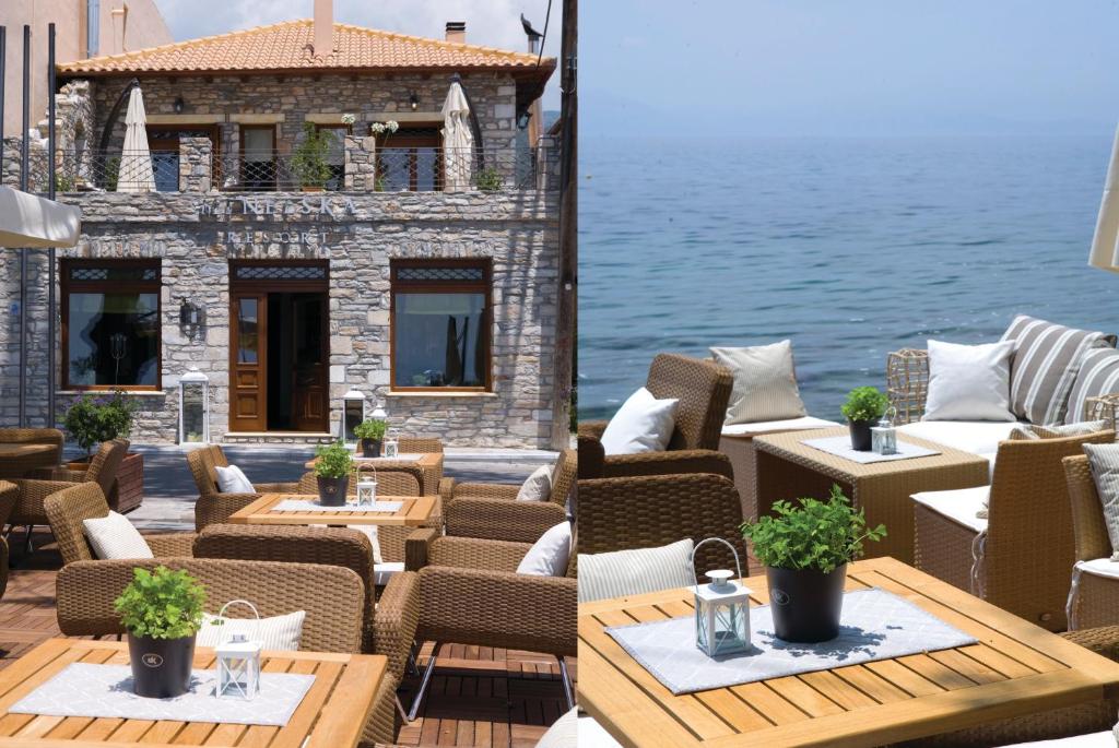 an outdoor patio with tables and chairs and the water at Hotel Minelska Resort in Kala Nera