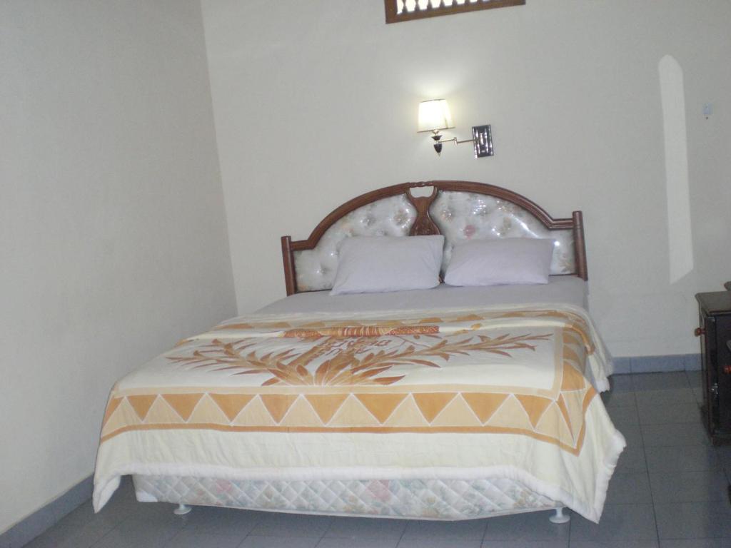 Postel nebo postele na pokoji v ubytování Adus Beach Inn