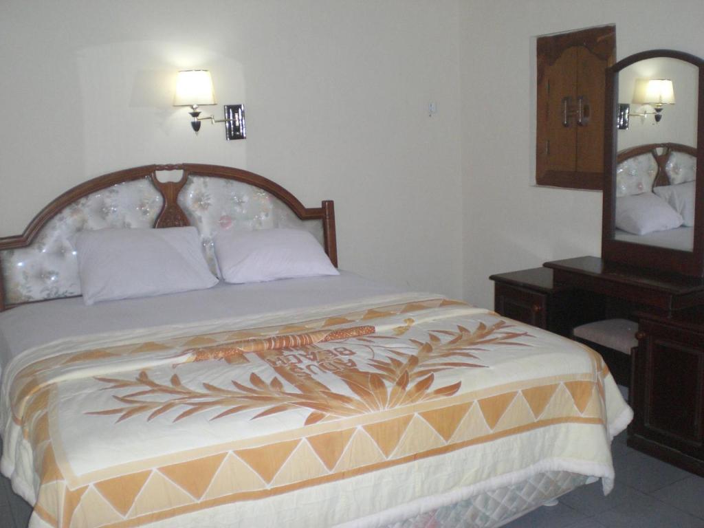 Postel nebo postele na pokoji v ubytování Adus Beach Inn