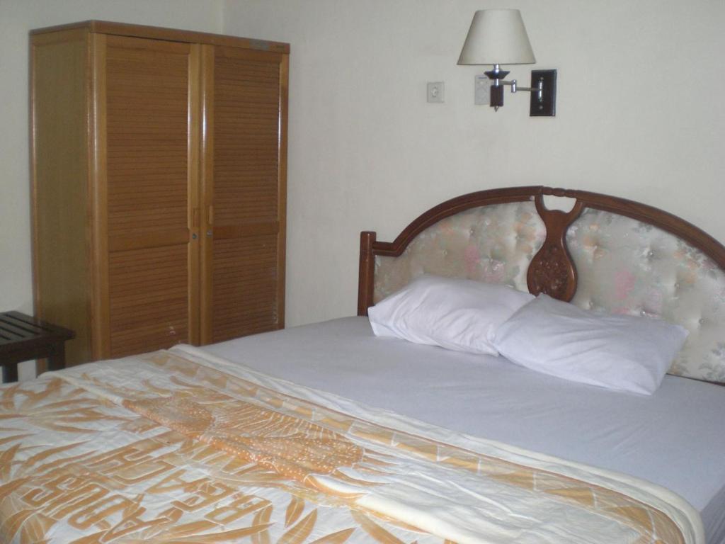 Postel nebo postele na pokoji v ubytování Adus Beach Inn