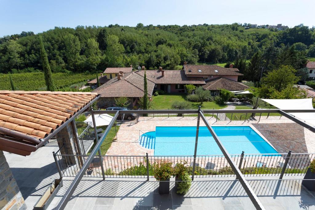 
a patio area with a pool and a tennis court at Guest House Valentincic in Nova Gorica
