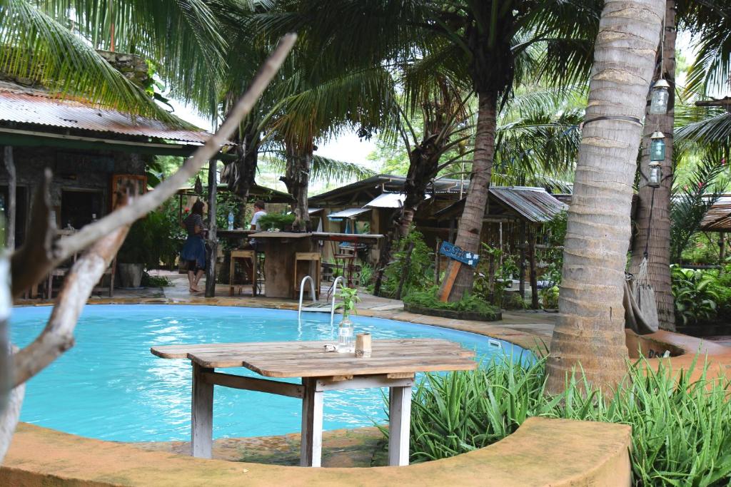 a picnic table in front of a swimming pool at Firefly Boutique Lodge in Bagamoyo