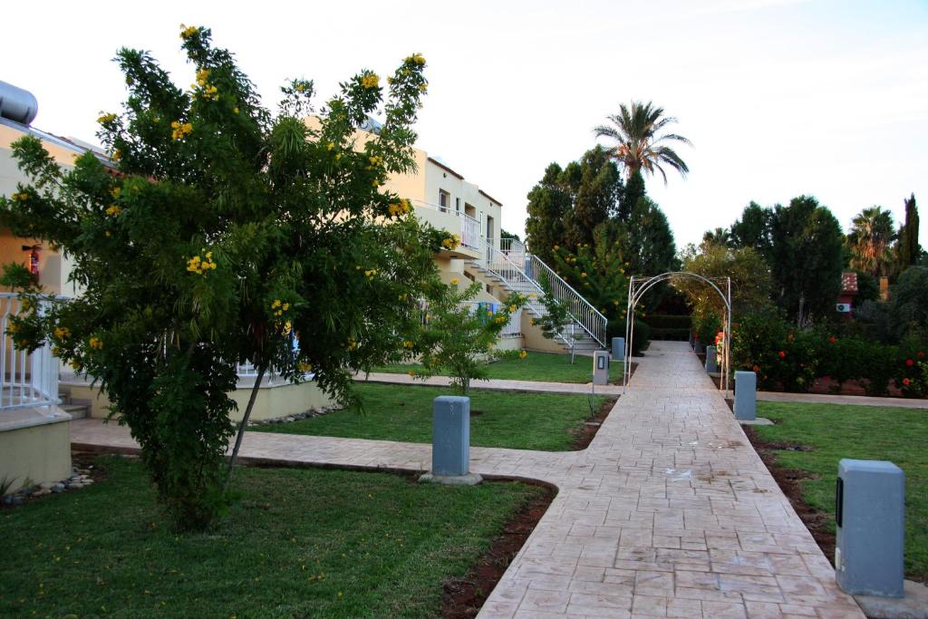 a walkway in a park next to a building at Makronisos Village in Ayia Napa