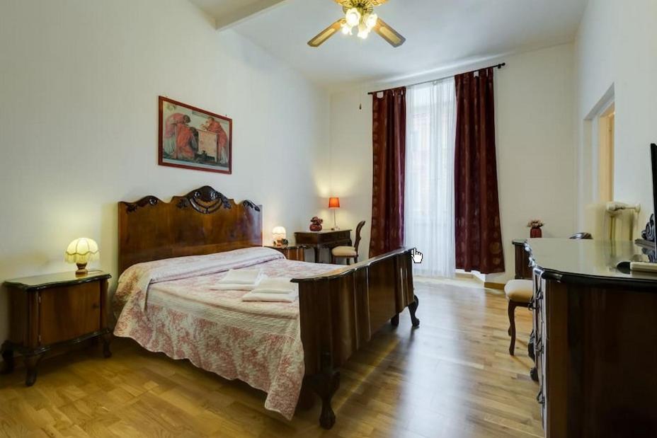 Schlafzimmer mit einem Bett und einem Deckenventilator in der Unterkunft ROMA CENTER, Rione Monti, Apartament in Rom