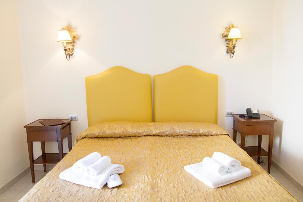Postel nebo postele na pokoji v ubytování Hotel Lanzillotta