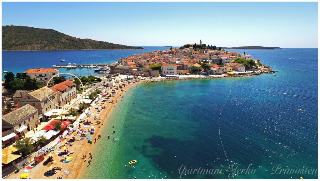an aerial view of a beach with people and the ocean at Apartments Jerko in Primošten