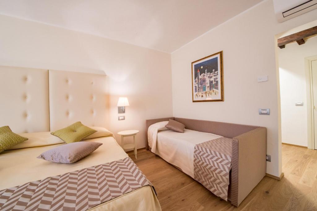 Postel nebo postele na pokoji v ubytování Hotel Il Palazzo